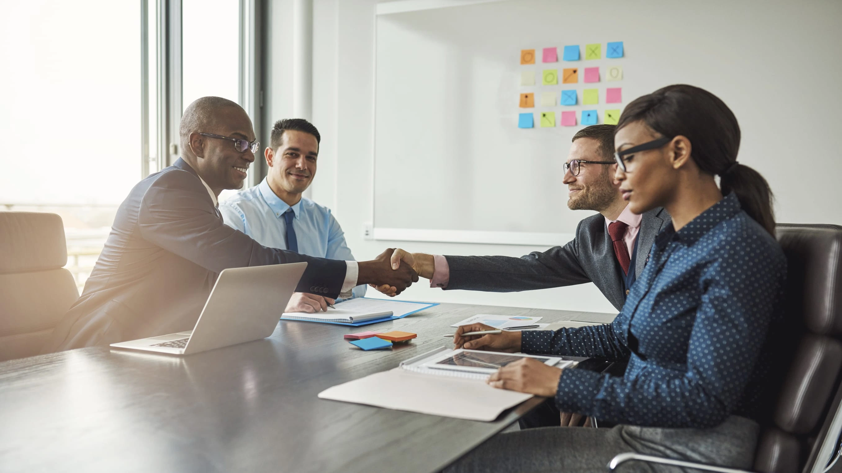Professionals completing an executive search meeting